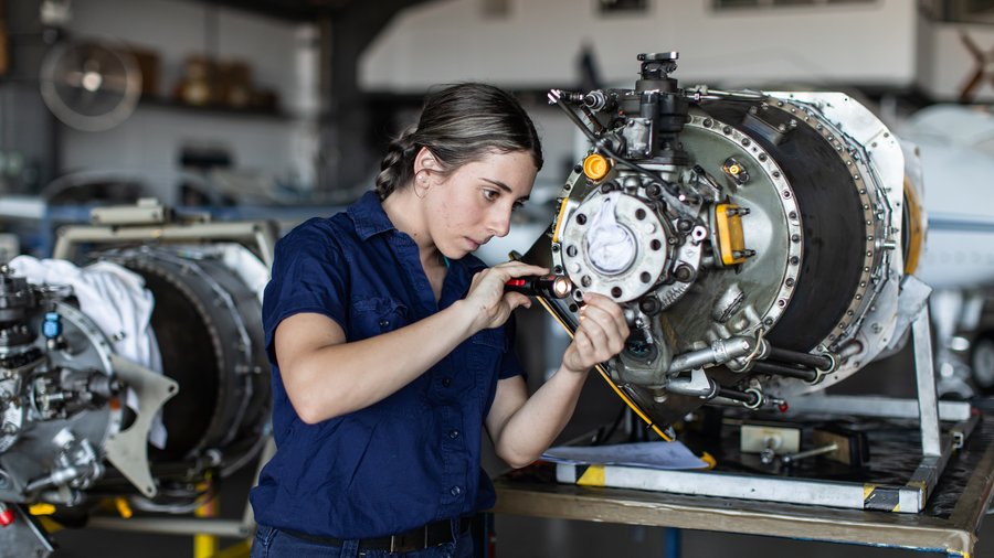 Woman working in manufacturing with tools