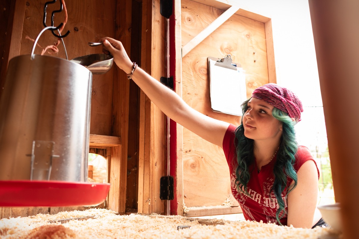 A young person working in a wood shop