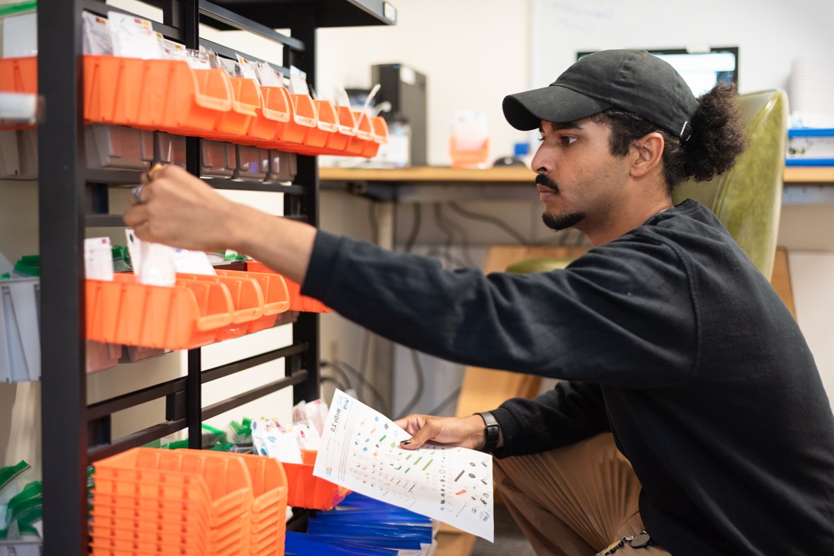 A person stacking things on a shelf